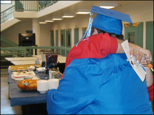a mother hugs her son at a fischer graduation