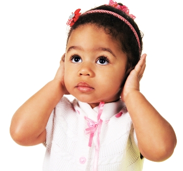 Young girl covering her ears.