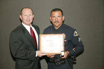Board Vice President Dr. Kenneth L. Williams with Officer Amador Nunez, Anaheim Police Activities, Junior Cadets Program