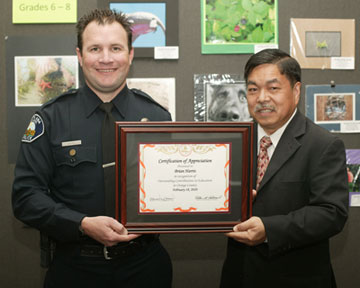 Brian Harris, Police Officer, Santa Ana Unified School District with Board Member Dr. Long Pham